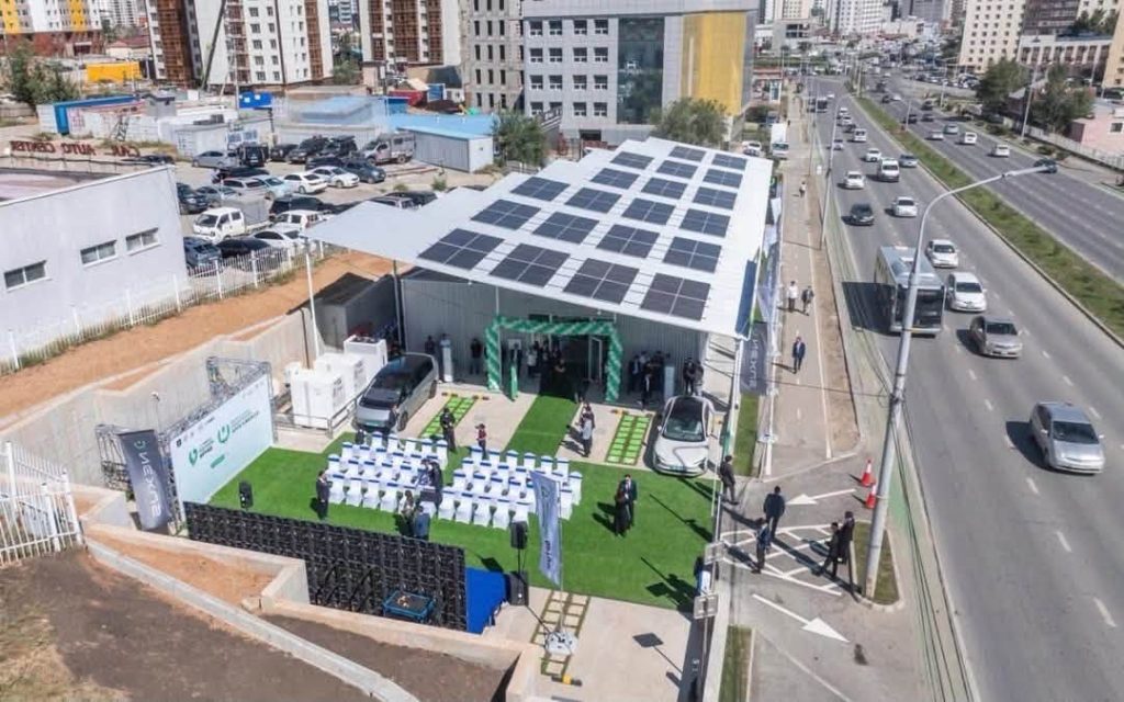 Aerial view of the NEXUS EV Station in Tasgan, Ulaanbaatar, with a solar canopy over the charging area